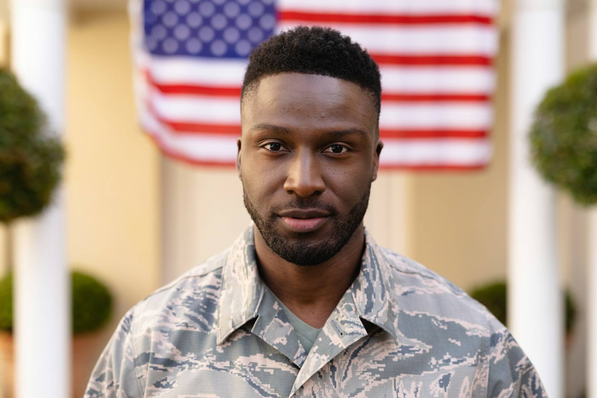 Portrait of confident male african american soldier wearing uniform against usa flag